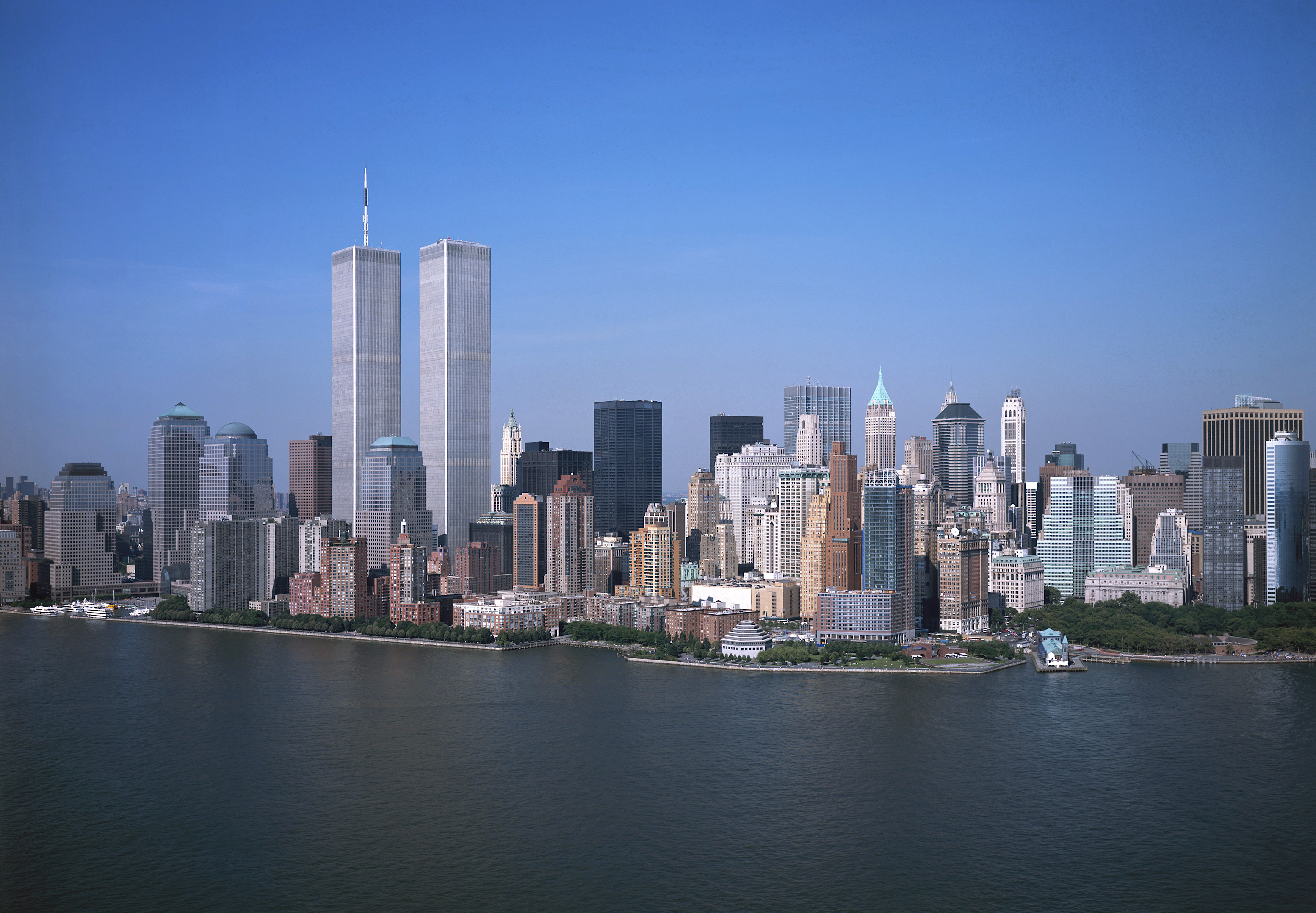 Archival view of the World Trade Center Twin Towers above Lower Manhattan, tying the founder's Excel journey to New York finance.